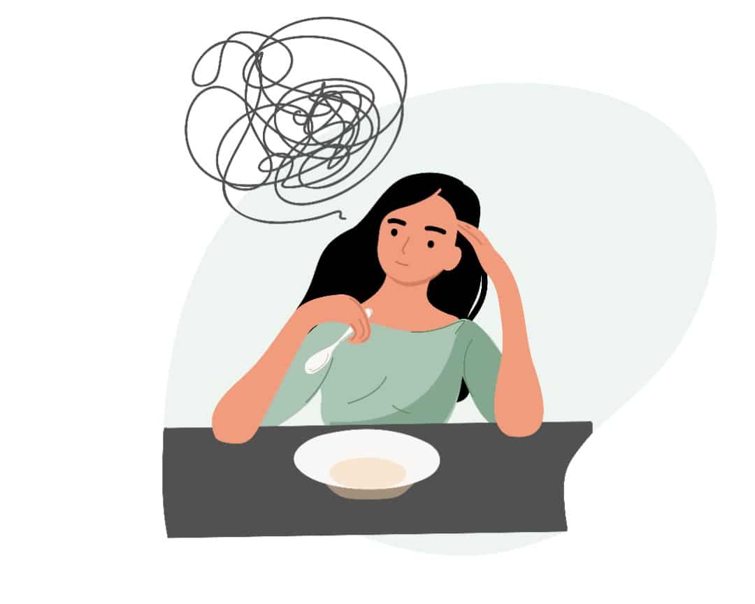Illustrated woman sits with a bowl of soup and looks anxious.